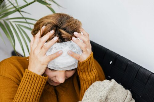 Person holding bandage head